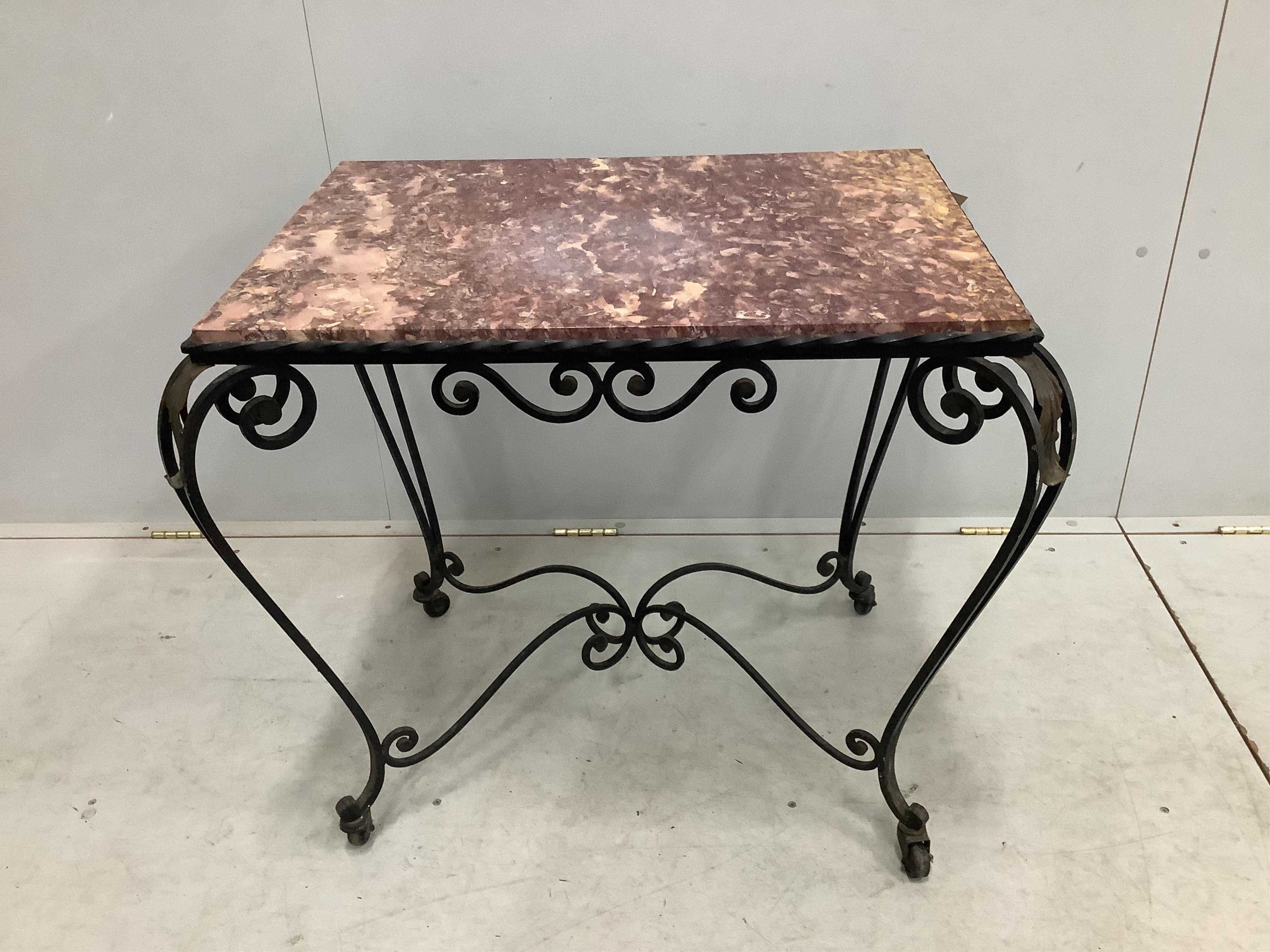 A rectangular wrought iron marble topped table, width 81cm, depth 58cm, height 68cm. Condition - fair